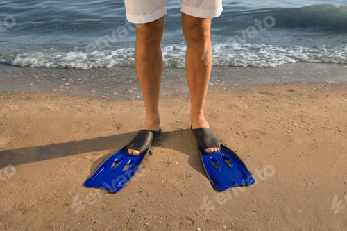 Preview: Man in flippers on sandy beach, closeup