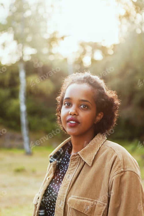 Preview: Woman enjoying a serene golden hour in the park