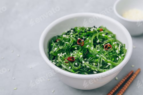Preview: Seaweed Salad with sesame seeds in bowl on gray concrete stone background