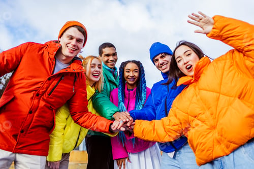 Preview: Multiracial group of young friends meeting outdoors in winter