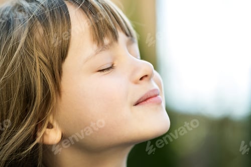Preview: Portrait of young pretty child girl with long hair enjoying warm sunny day in summer