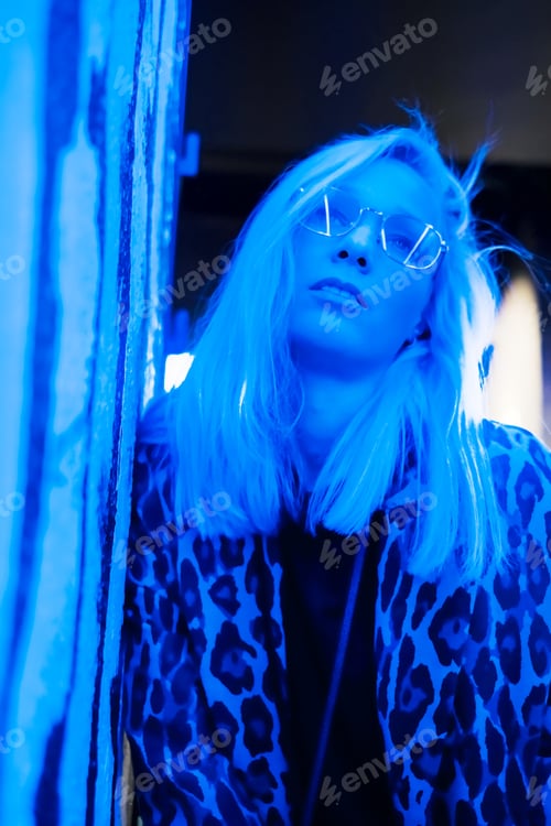 Preview: Woman face with glasses in metal frame reflect neon light