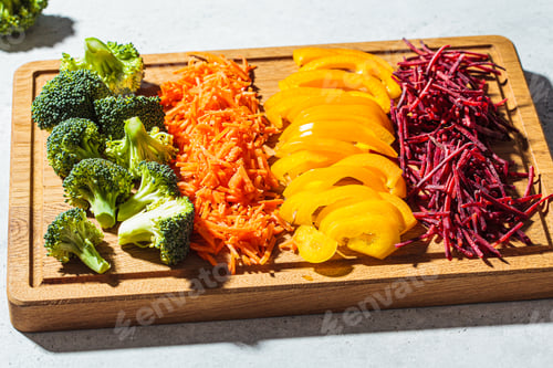 Preview: Sliced raw vegetables on wooden board.