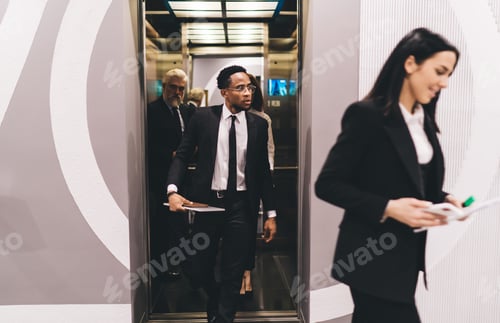 Preview: Multiethnic colleagues at work leaving elevator