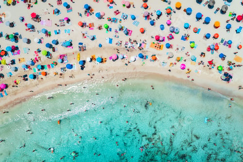 Preview: Aerial view of sandy beach with umbrellas and sea