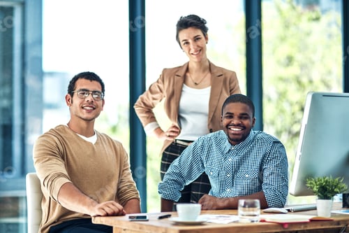 Preview: We make success look easy. Portrait of a group of designers grouped together in an office.