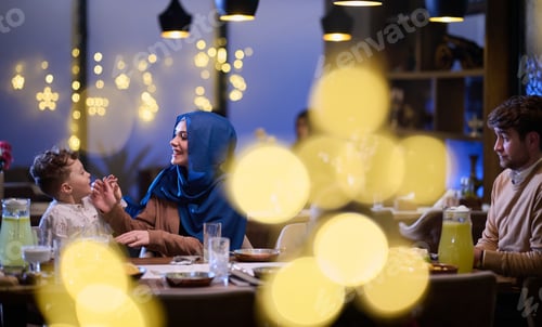 Preview: In a modern restaurant, an Islamic couple and their children joyfully await their iftar meal during