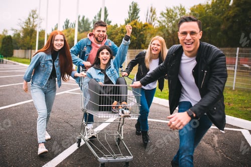 Preview: Group of four young diverse friends in jeanse outfit look carefree, young and happy on city's