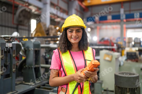 Preview: Female engineer or factory worker working in modern industrial factory