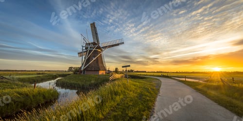 Preview: Wooden windmill with cycling track at sunset