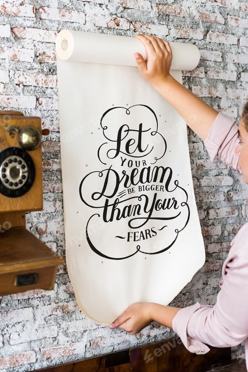 Preview: A woman holding a poster with motivation quote