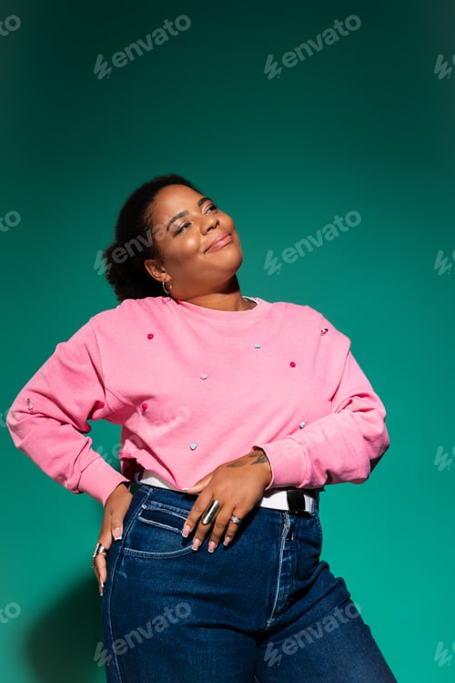 Preview: Stylish plus size woman confidently embraces autumn fashion in vibrant studio setting