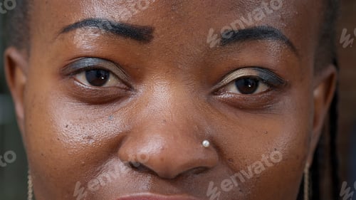 Preview: Macro shot of happy woman wearing makeup and blinking