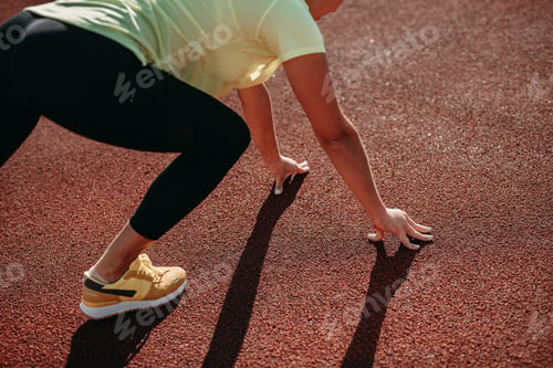 Preview: Close up of female in sportswear preparing for morning run