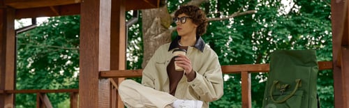Preview: Young handsome student enjoying a refreshing walk in nature on a crisp sunny day