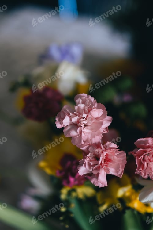 Preview: a bouquet of flowers sitting on top of a table with some flowers in front of