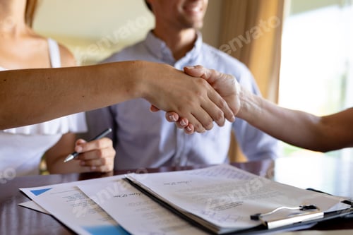 Preview: Young woman and financial adviser shaking hand