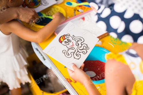Preview: A child draws with colored sand picture. Cartoon characters.