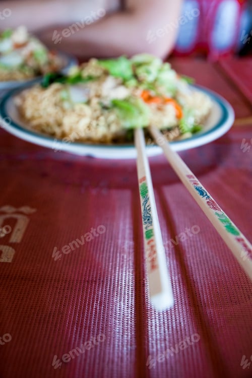 Preview: Asian rice dish with chopsticks