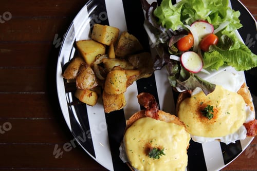 Preview: Egg Benedict With Bacon And Potato On Wood Background