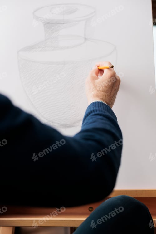 Preview: Senior man drawing with pencil on canvas