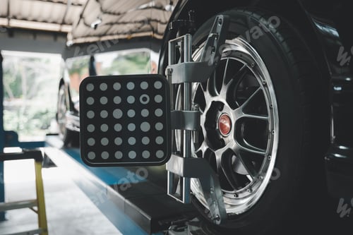 Preview: Closeup of car wheel alignment at auto repair center. Vehicle maintenance service in an automotive