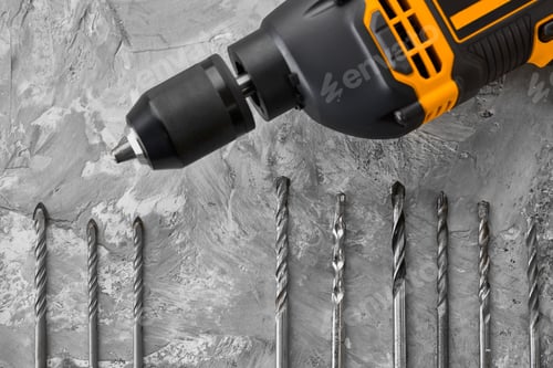 Preview: Power Drill and Drill Bits on Gray Surface