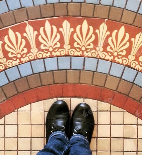 Preview: Personal perspective of person standing above mosaic tiles on floor