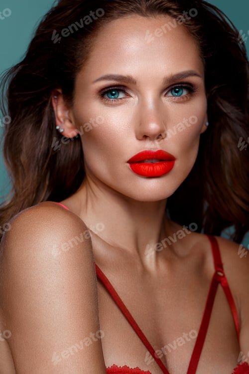 Preview: Beautiful sexy woman in a Hollywood manner with curls, natural makeup and red lips..