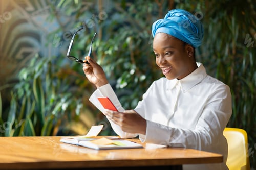 Preview: Emotional black woman reading emails on smartphone, copy space