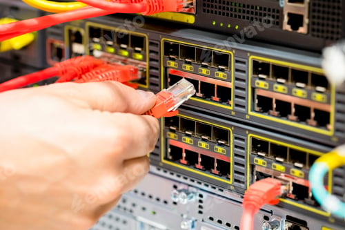 Preview: Hand Plugging Fiber Cable Into Switch In Datacenter