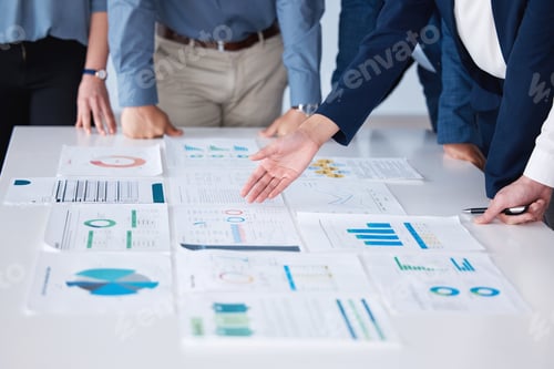 Preview: Unknown group of diverse businesspeople using paperwork during a boardroom meeting in an office. Cl