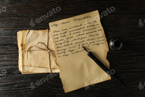 Preview: Old letters, letter with text and pen on wooden background, top view