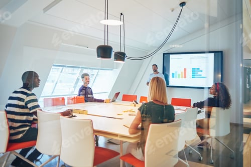 Preview: Diverse group of colleagues talking together during an office presentation