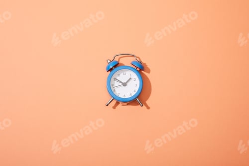 Preview: top view of classic alarm clock on peach background