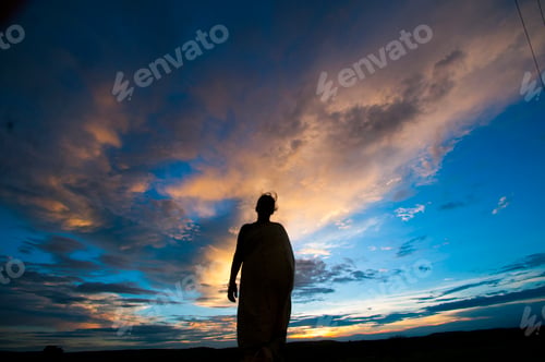 Preview: Silhouette of woman enjoying freedom at sunset.