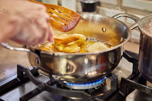 Preview: Cooking apple pancake. Chef flips the Apple Donut in the simmering oil