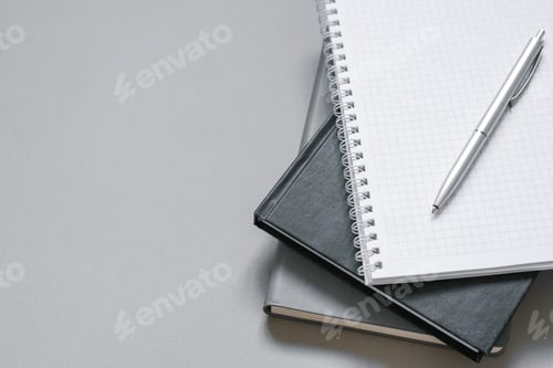 Preview: Notebooks and Diaries on Gray Desktop with Pen