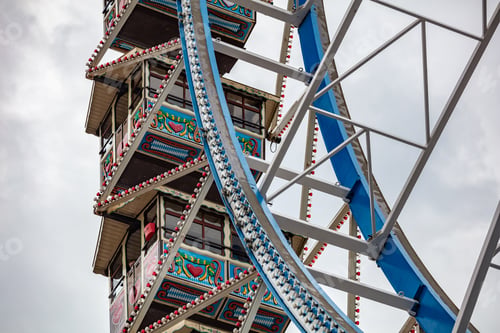 Preview: Ferris wheel closeup detail view on cloudy sky. Oktoberfest, Bavaria, Germany