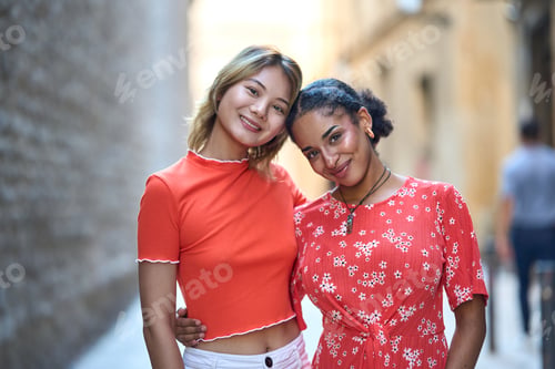 Preview: Lesbian couple standing embraced by the back
