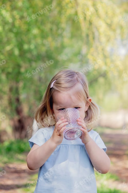 Preview: little girl drinking water from a glass