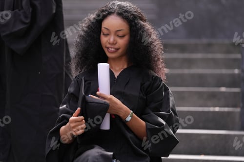 Preview: graduates in caps and gowns beam with joy, embracing and cheering in celebration.