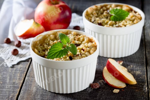 Preview: Dessert crumble with apple and nuts on a dark wooden table