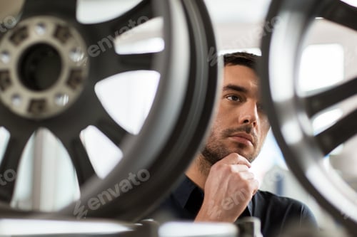 Preview: male customer choosing wheel rims at car service