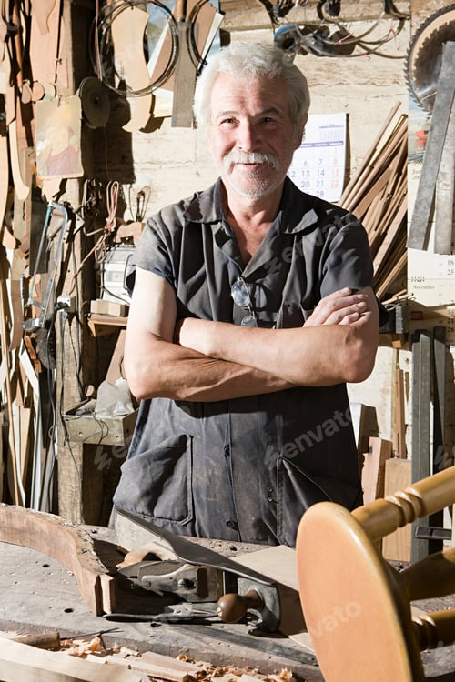 Preview: Smiling craftsman in a woodworking workshop