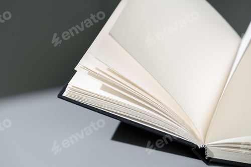 Preview: Blank open notepad on gray background studio shot