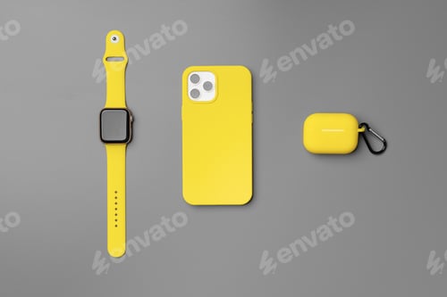 Preview: Yellow smartphone, smartwatch and earphones on gray background