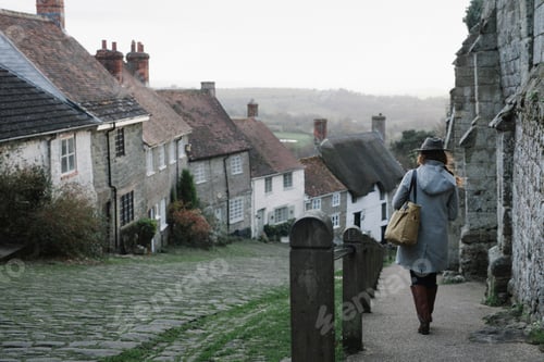 Preview: A woman at the top of Gold Hill, a steep cobbled street in Shaftesbury.