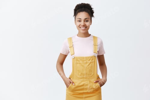 Preview: Pleasant cute female dark-skinned employee helping customers find right item to purchase. Joyful fri