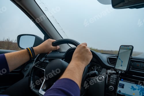 Preview: Person Driving by the road at foggy autumn highway